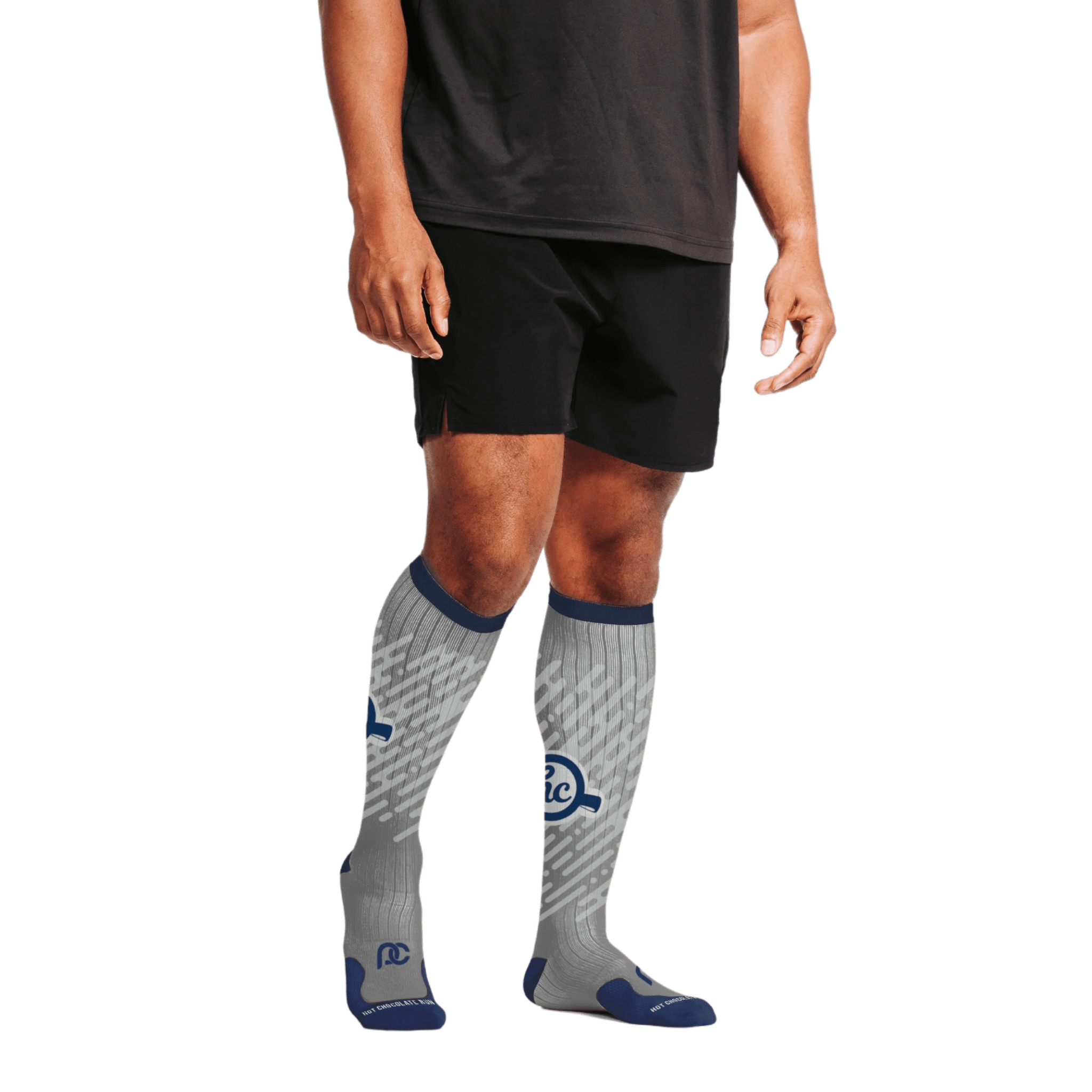 Person wearing black shorts and gray knee-high socks with HC logo