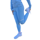 Woman stretching in blue leggings with a visible Hot Chocolate Run logo