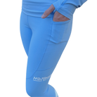 Close up of blue leggings with a pocket and Hot Chocolate Run logo