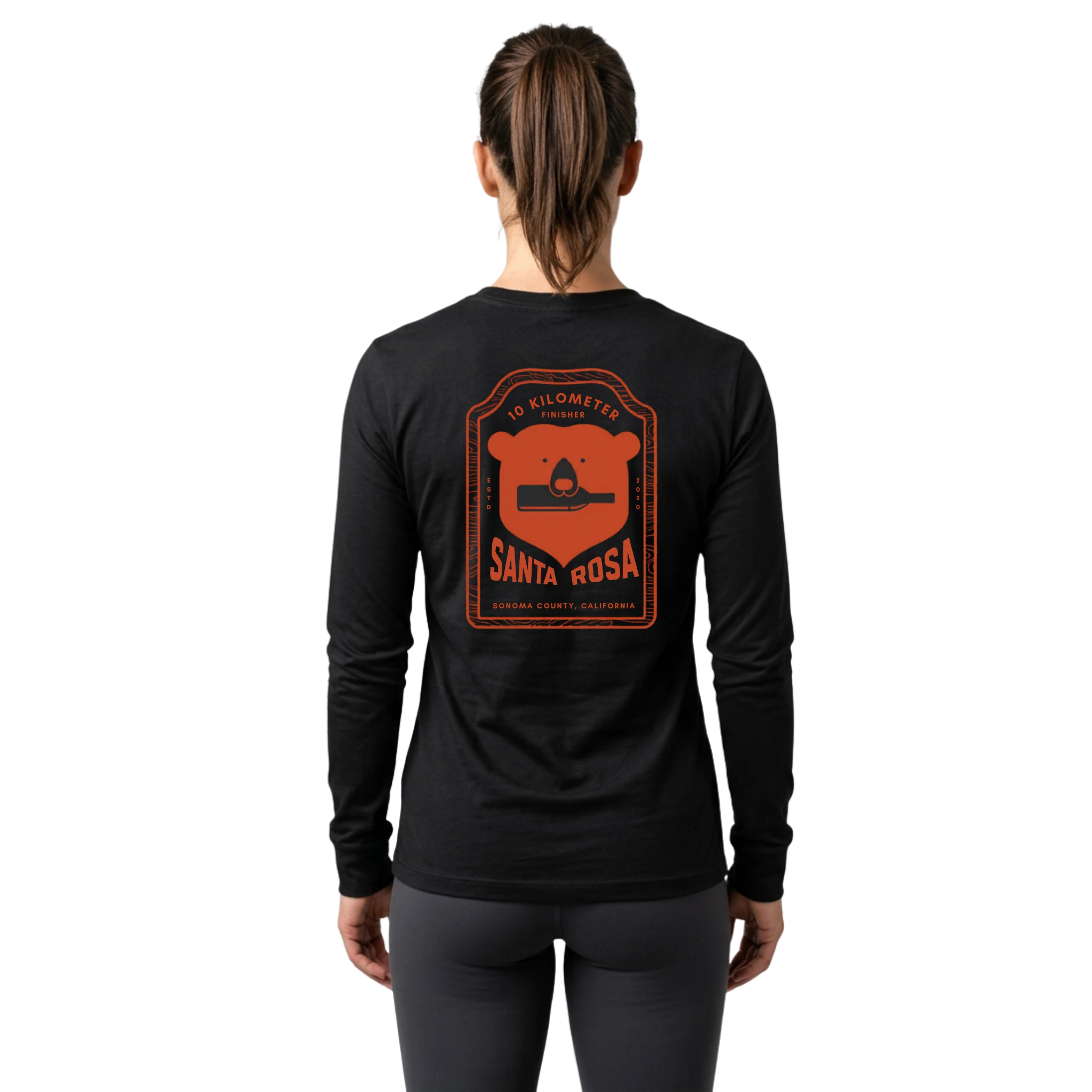 Woman wearing a black long-sleeve shirt with orange Santa Rosa Marathon 10K graphic on the back