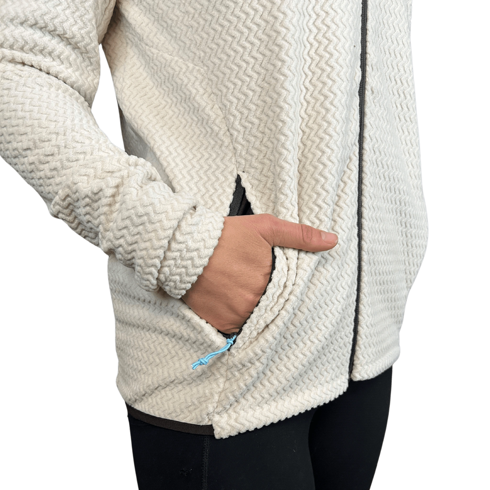 Close-up of a person wearing a textured white jacket with a hand in a pocket
