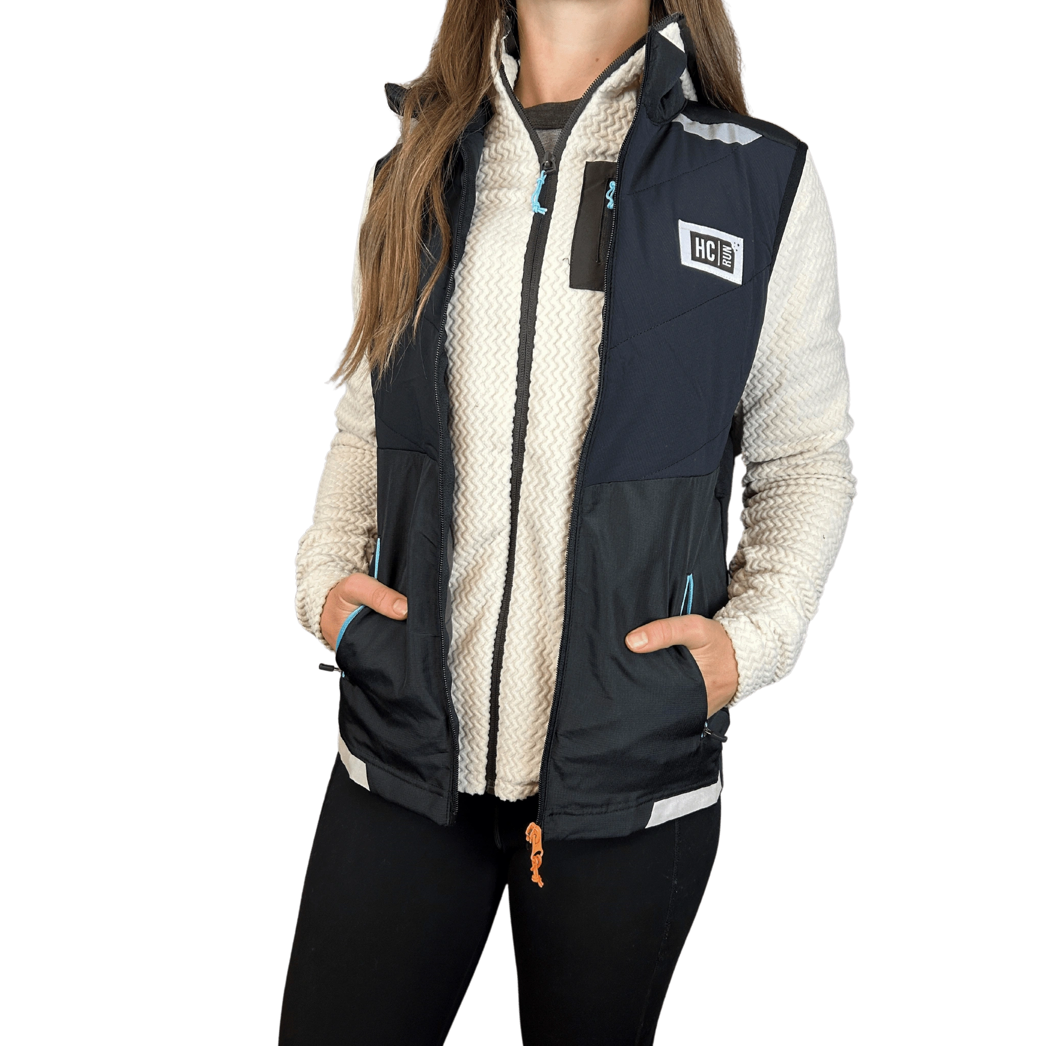Person wearing a white fleece jacket under a black running vest with HC Run logo on left chest