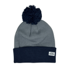 Cool blue pom-pom beanie with white label in corner
