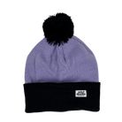 Lavender pom-pom beanie with white label in corner