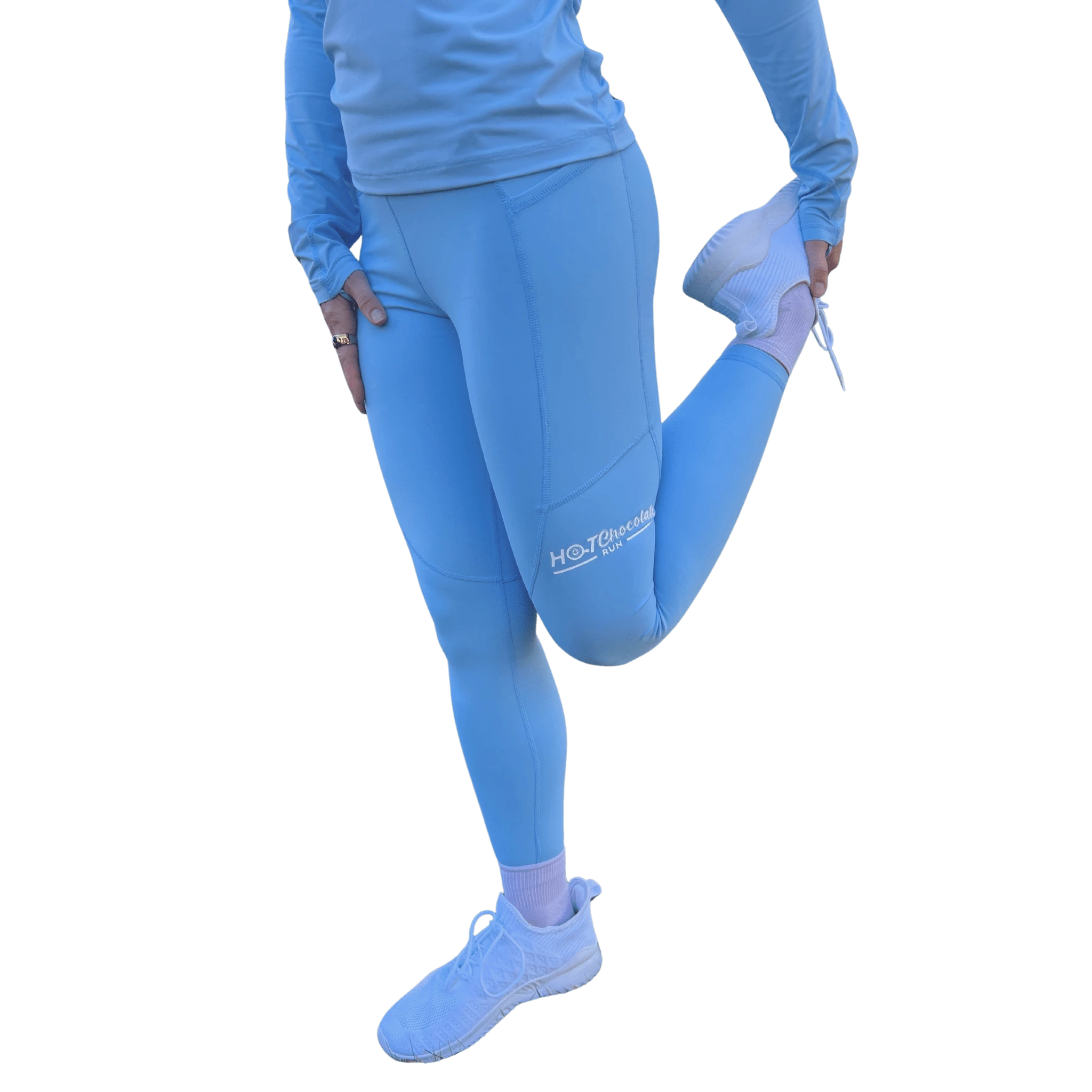 Woman stretching in blue leggings with a visible Hot Chocolate Run logo