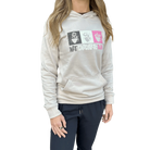 Woman wearing a beige hoodie with colorful graphic design and Hot Chocolate Run text