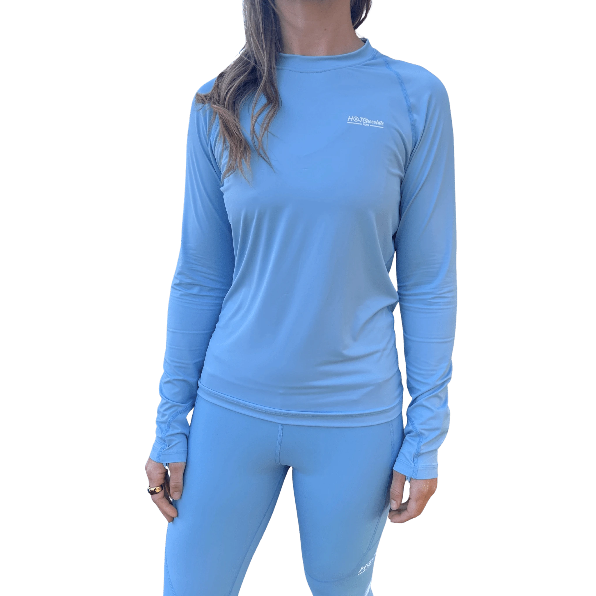 Woman wearing a light blue long-sleeve shirt with small Hot Chocolate Run logo on left chest
