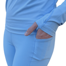 A close up of a hand in a light blue long-sleeve shirt with built in thumb hole