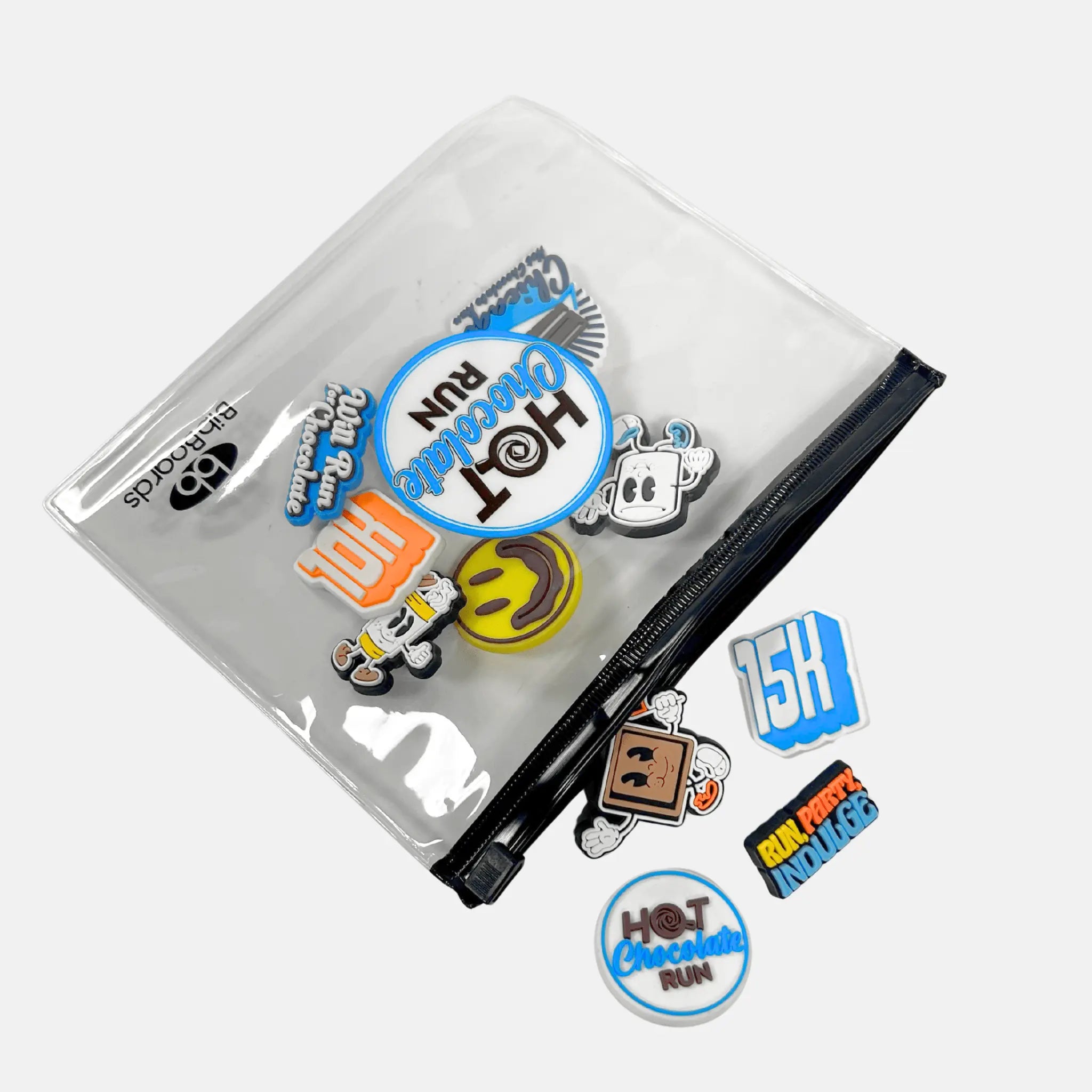 Clear pouch with various 'Hot Chocolate Run' themed MeSnaps pouring out