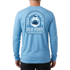 Man wearing long sleeve light blue shirt with Old Port Half Marathon and 5K graphic on back