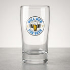 Clear glass with WILL RUN FOR BEER label on a light gray background