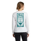 Woman wearing a white long-sleeve shirt with a green graphic of the Fargo Theatre on the back