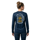 Woman wearing a navy long-sleeve shirt with a graphic of a beer mug and text Will Run for Beer on the back