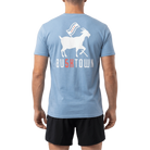 Person wearing a blue t-shirt with a graphic and 'BU5KTOWN' text on the back