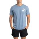 Person wearing a blue t-shirt with a white goat graphic on left chest