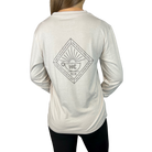 A person wearing a long sleeve light brown gray t-shirt with a graphic design