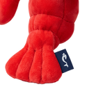 Red plush toy with a brand tag