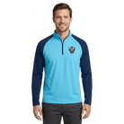Man wearing a light blue quarter zip with North Shore Classic logo