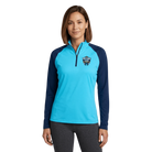 Woman wearing a light blue quarter zip with North Shore Classic logo